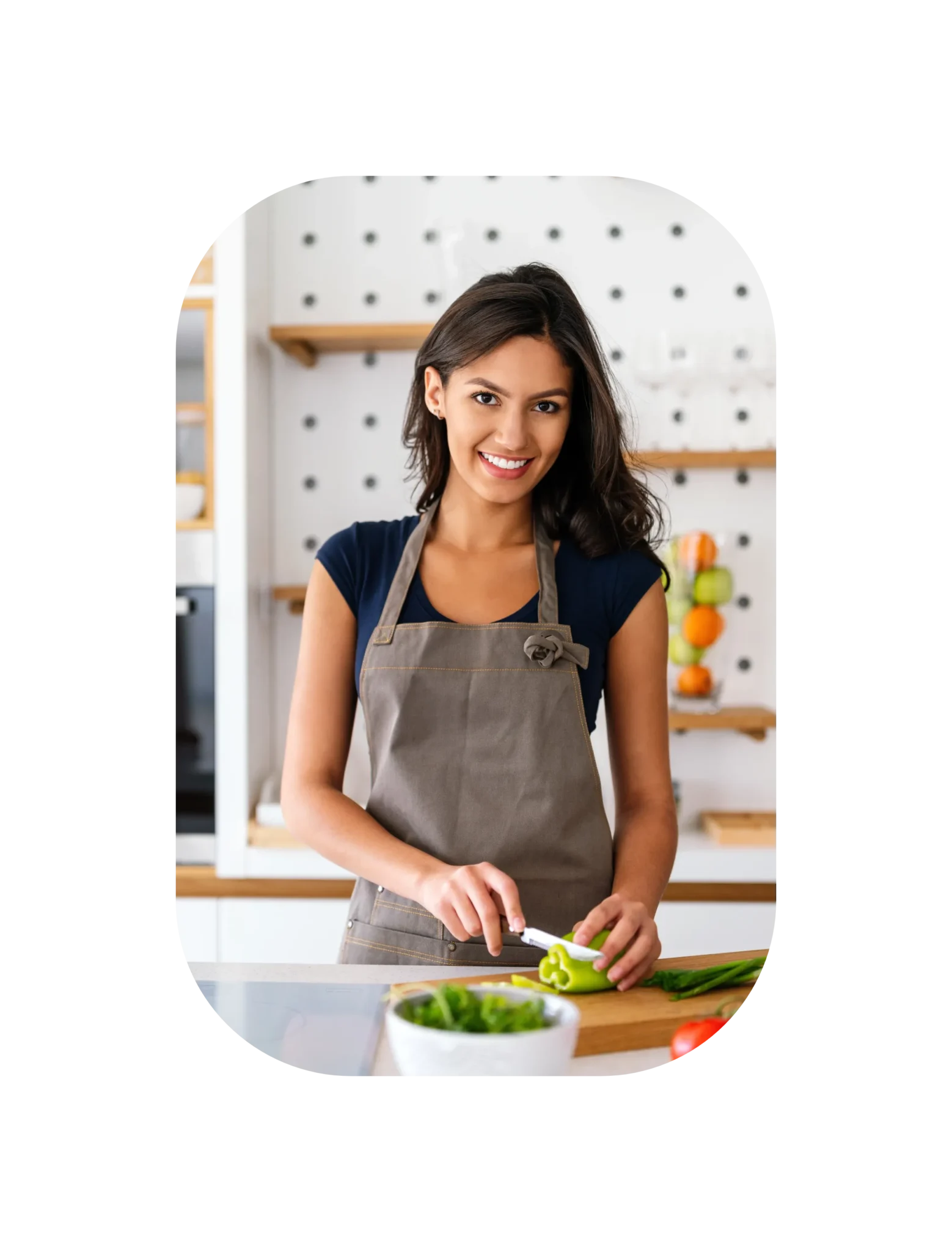 Sarah slicing green bell pepper in a modern kitchen.