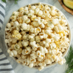 Dill pickle popcorn in bowl with garlic and dill