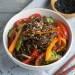 Black bean noodles vegetarian recipe with sauce and sesame seeds