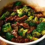 Plate of beef and broccoli stir-fry with vibrant vegetables